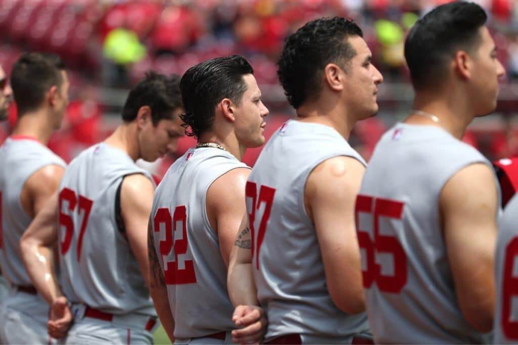 Reds play in sleeveless throwback uniforms against St. Louis Cardinals